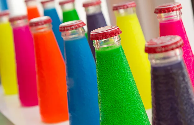 bright colored drinks on glass bottles