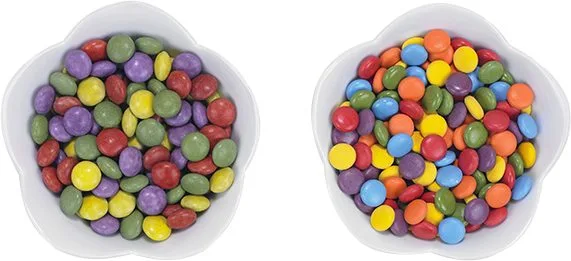 Two adjacent cereal bowls filled with coloful cereal.