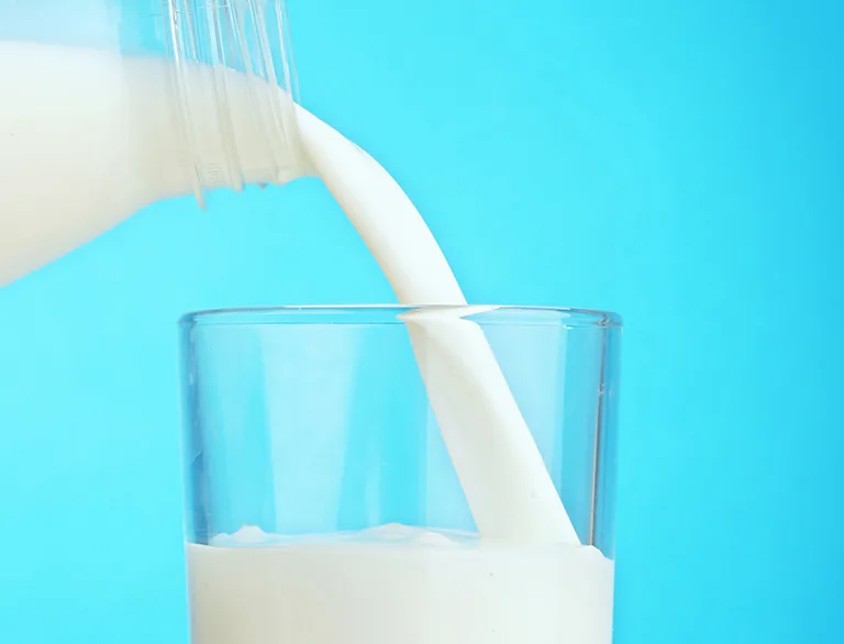 milk being poured into a glass