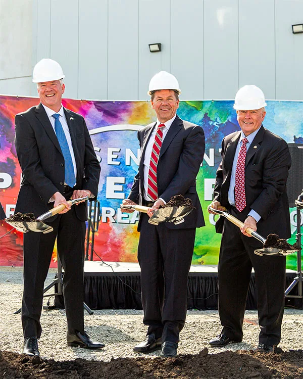 sensient groundbreaking event employees with hard hats and shovels