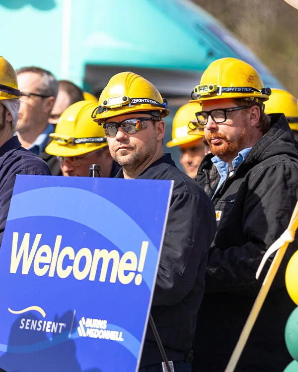 sensient groundbreaking event employees with hard hats and welcome sign
