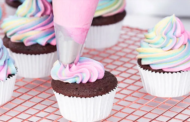 rainbow frosting on chocolate cupcake