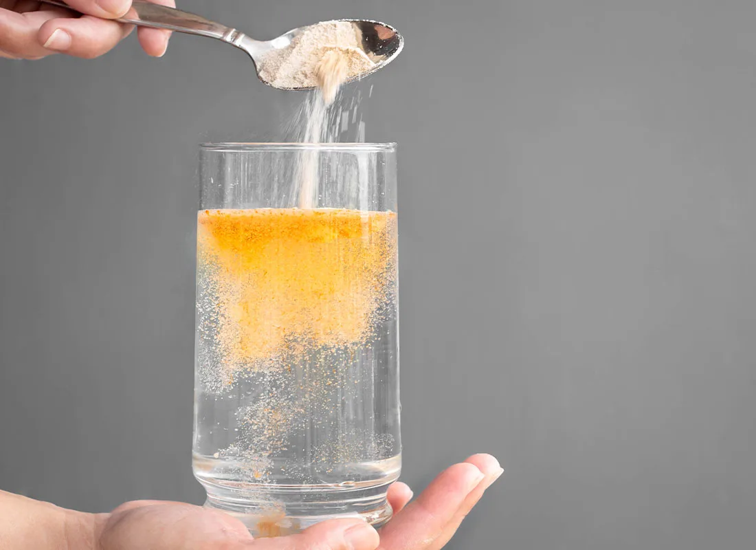 dissolving orange powder into water