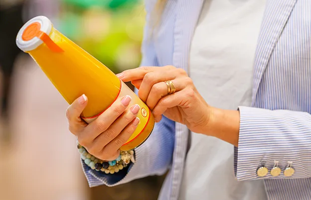 woman reading beverage label
