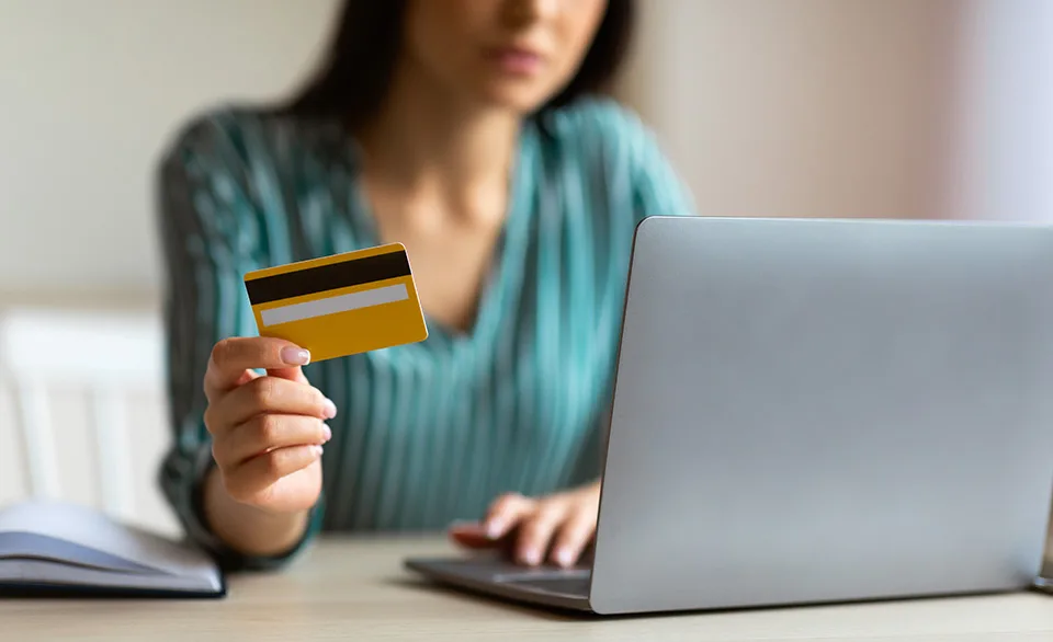 woman holding credit card to order online