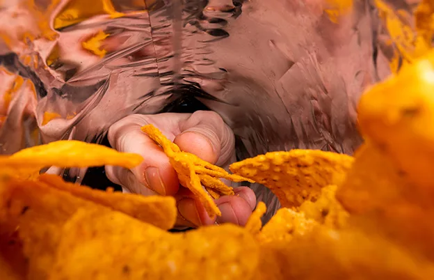 hand reaching into chip bag