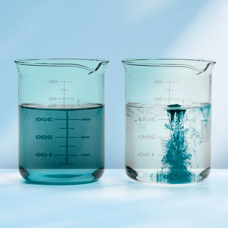 beakers filled with blue powder dissolved in water