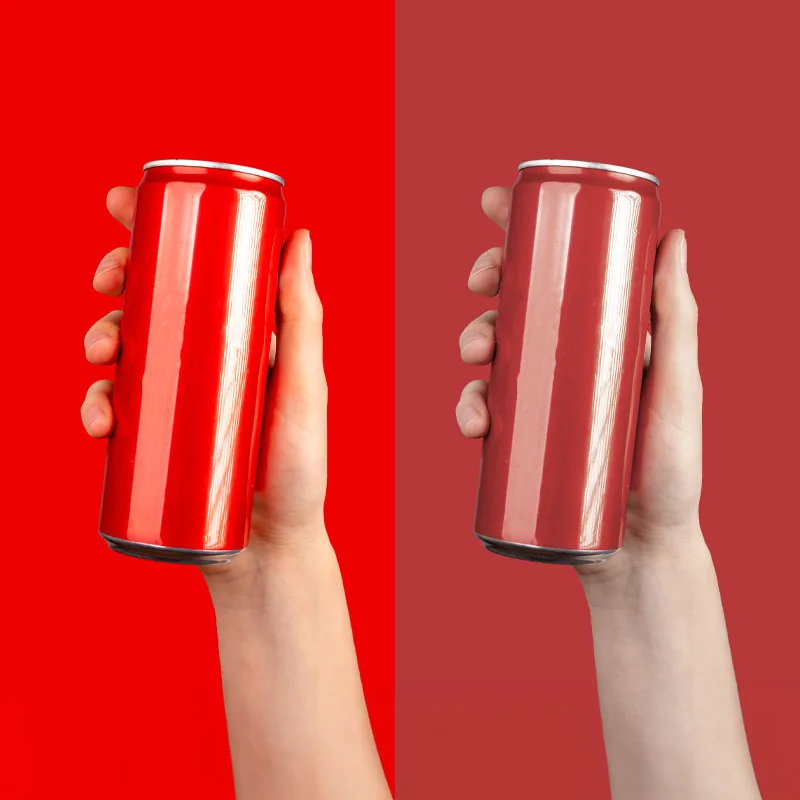 two red soda cans side by side but different shades of red