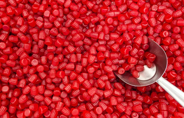 red candies with a candy scoop in it